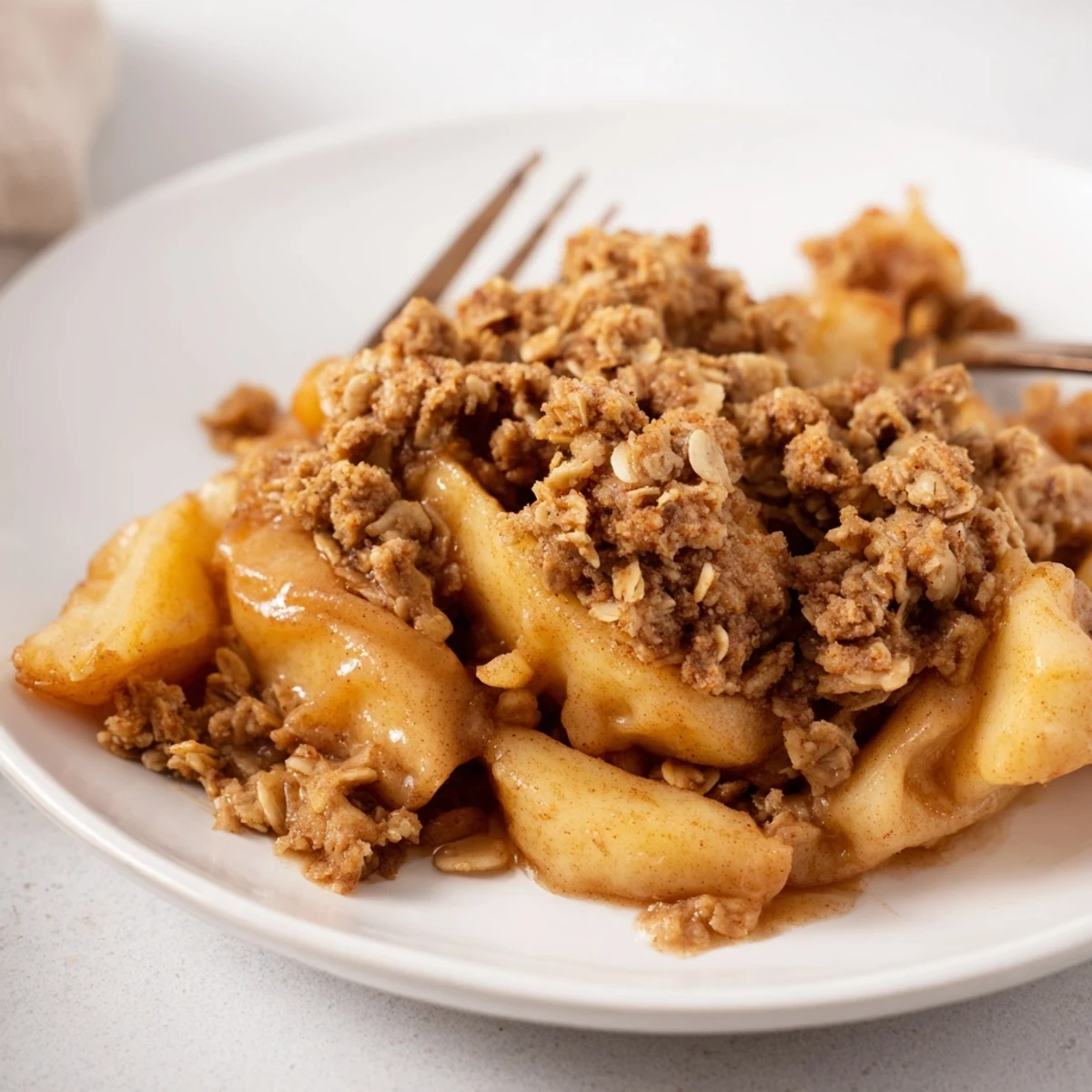 Warm Cinnamon Apple Crisp topped with golden oats, perfect for cozy family gatherings.  