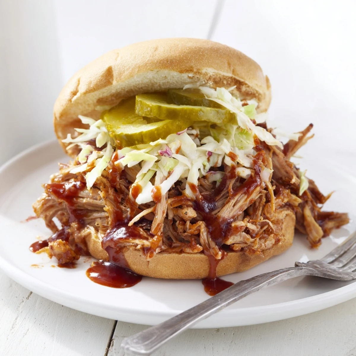 Tender BBQ pulled pork sandwiches served on toasted buns, perfect for summer gatherings.  