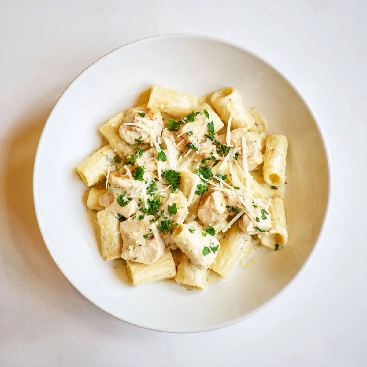 Golden chicken pieces and al dente rigatoni nestled in a delicious Creamy Garlic Parmesan sauce.