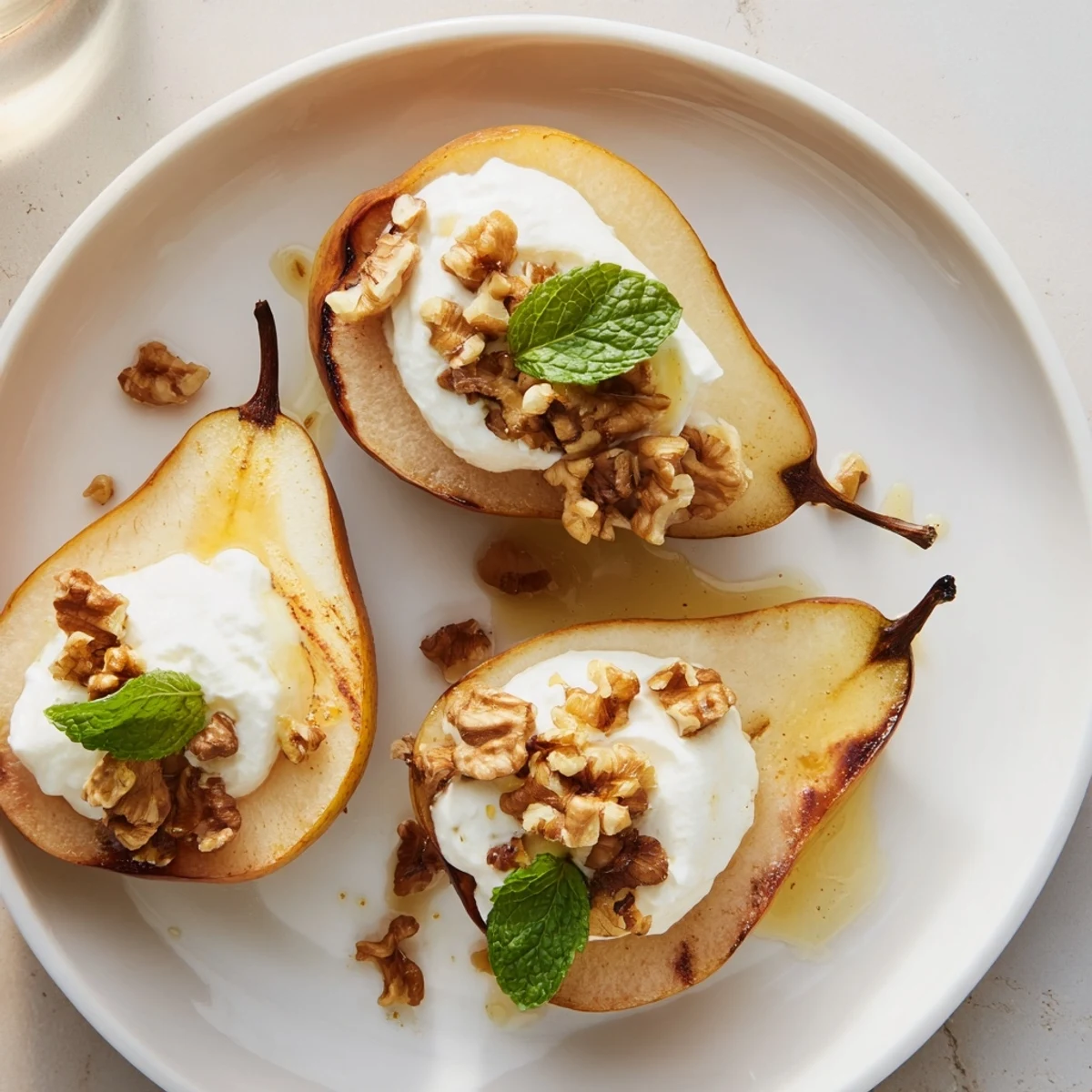 Golden-brown roasted pears, topped with walnuts and creamy Greek yogurt; perfect treat.