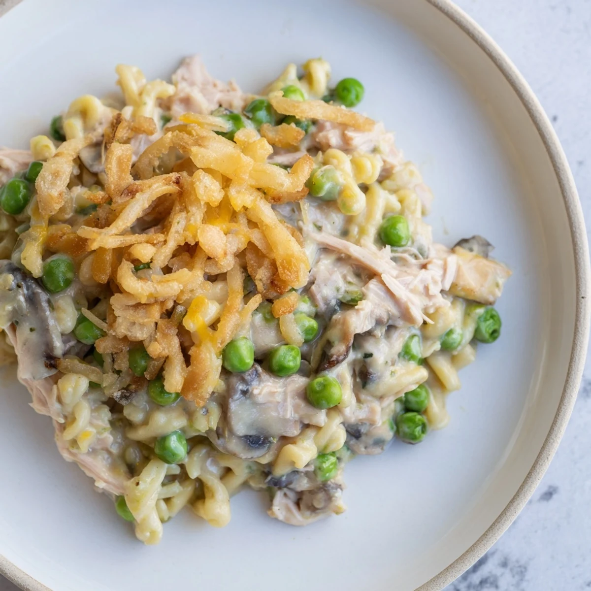 Warm, comforting Tuna Noodle Casserole with a crispy onion topping, perfect for dinner tonight.