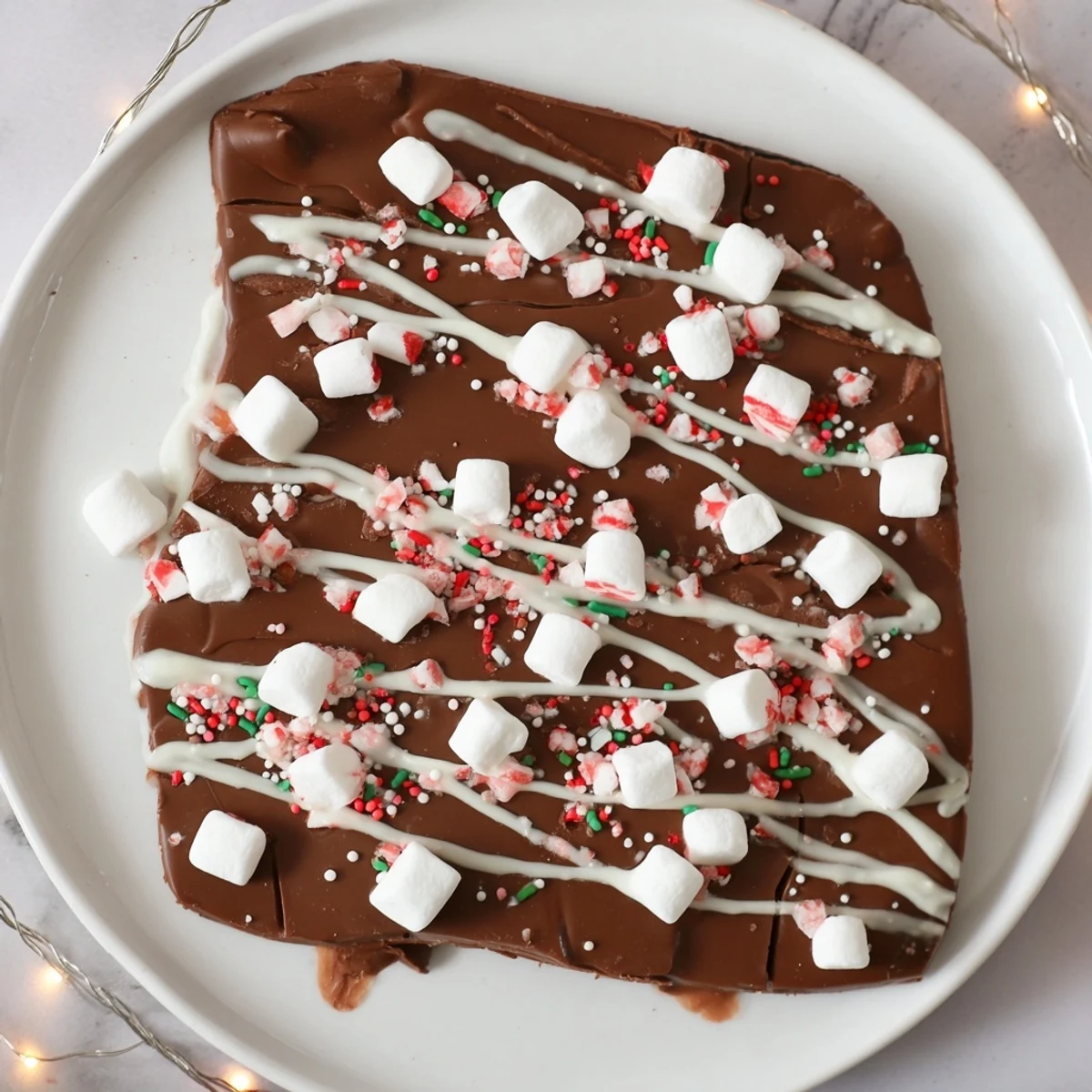 Decadent Viral Hot Chocolate Bomb Bark, a festive dessert layered with marshmallows and cocoa ready to share.