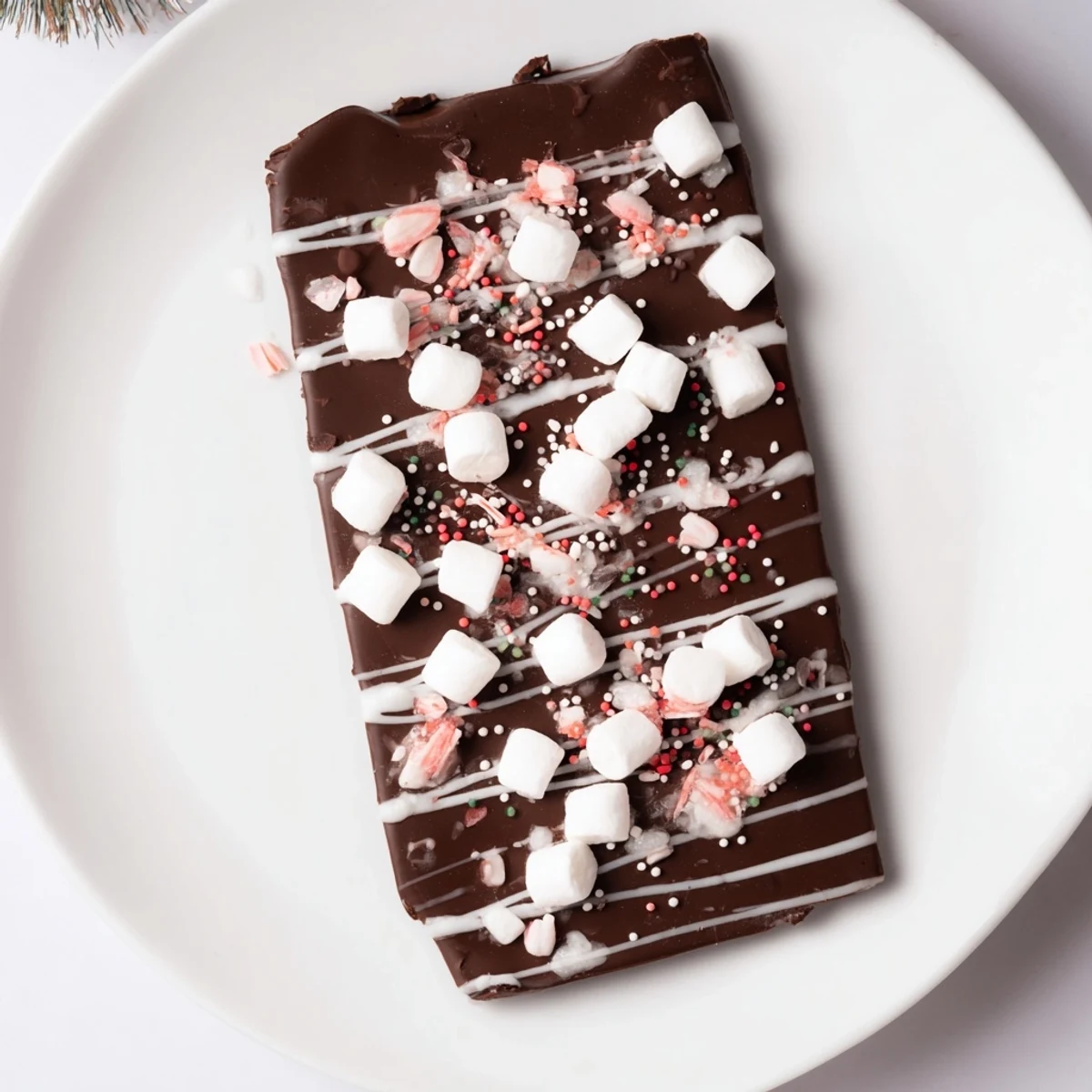 This homemade Viral Hot Chocolate Bomb Bark features a crackly chocolate base, swirls of white chocolate, and yummy sprinkles.