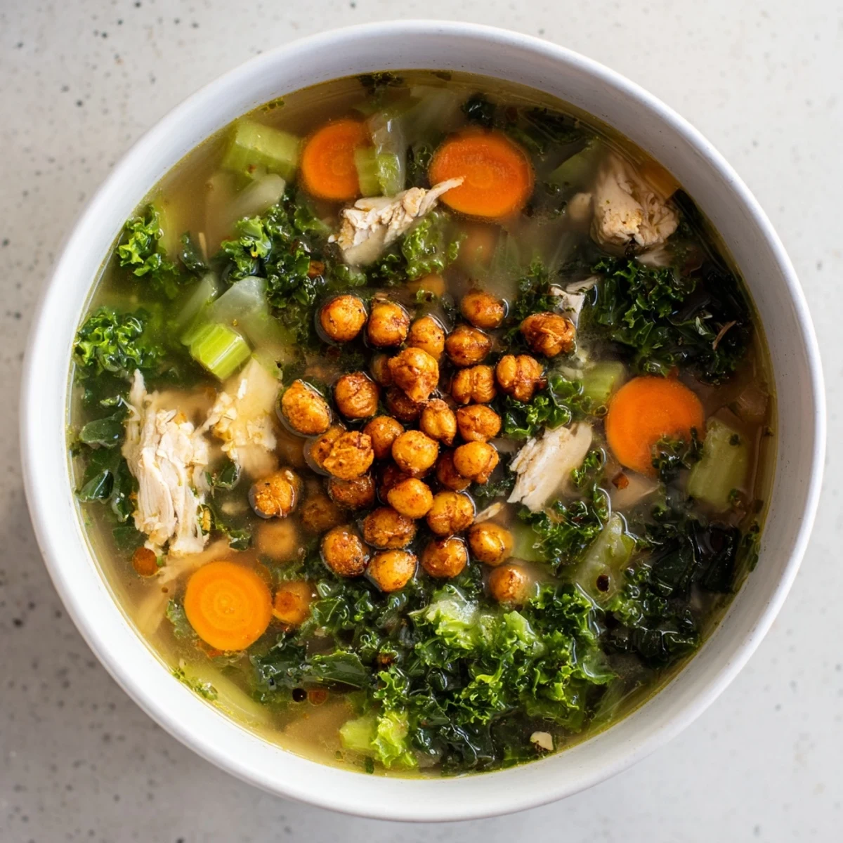 Close-up of a delightful Chicken Kale Soup, showcasing tender chicken pieces and vibrant kale.