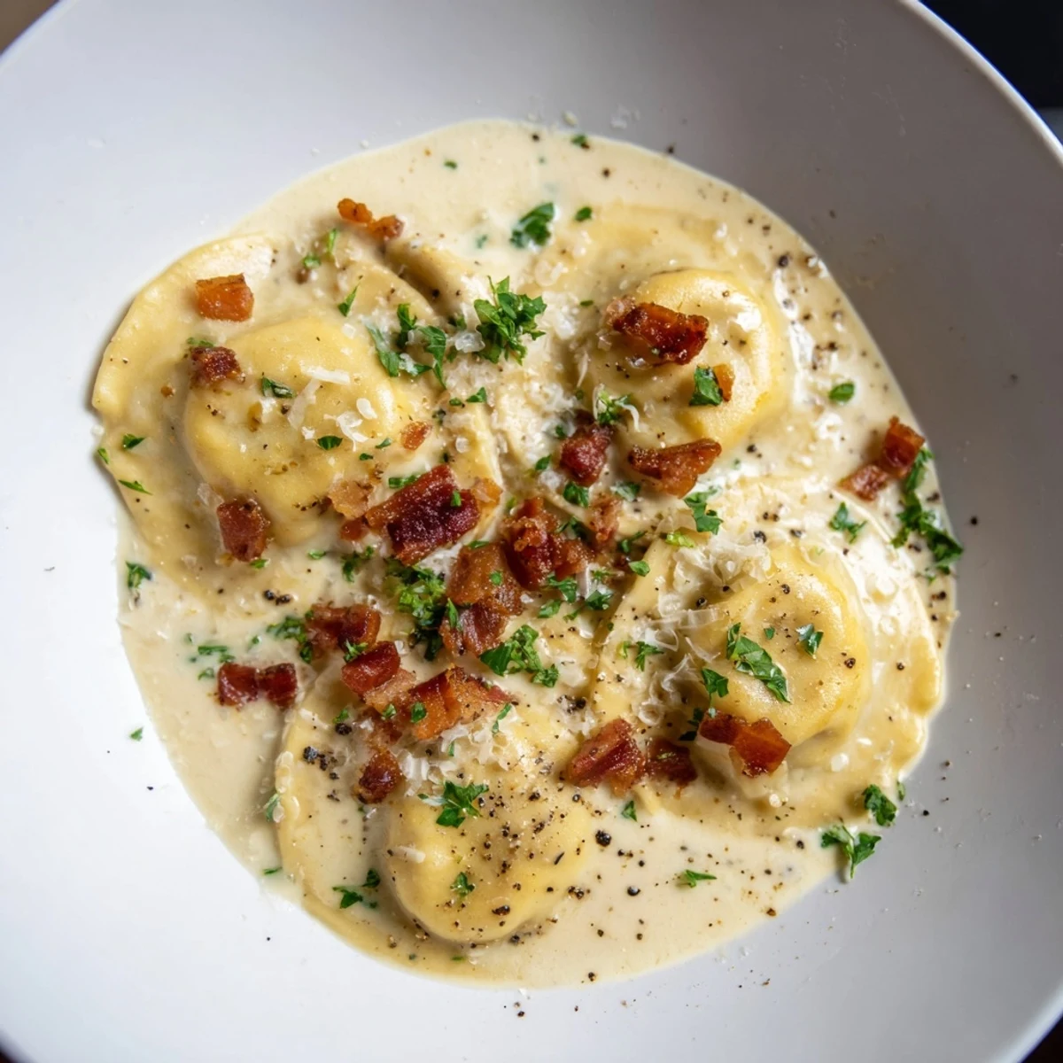 Savory Olive Garden Ravioli Carbonara, a comforting Italian-American dish topped with fresh parsley and Parmesan cheese.