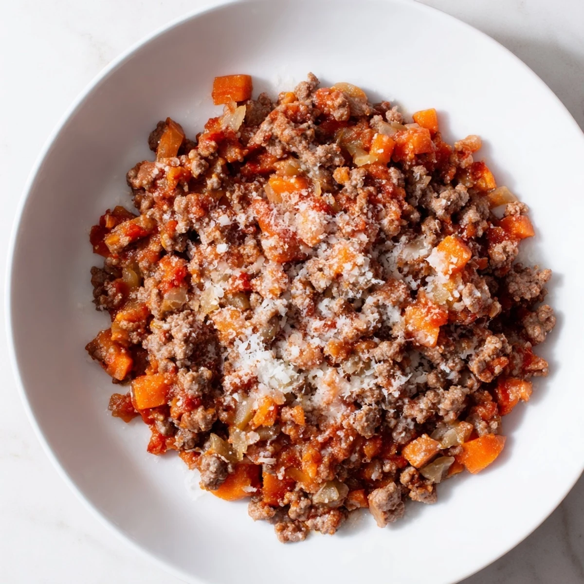 Close-up of a bubbling Classic Tuscan Ragu; the savory aroma of slow-cooked meat and tomatoes.