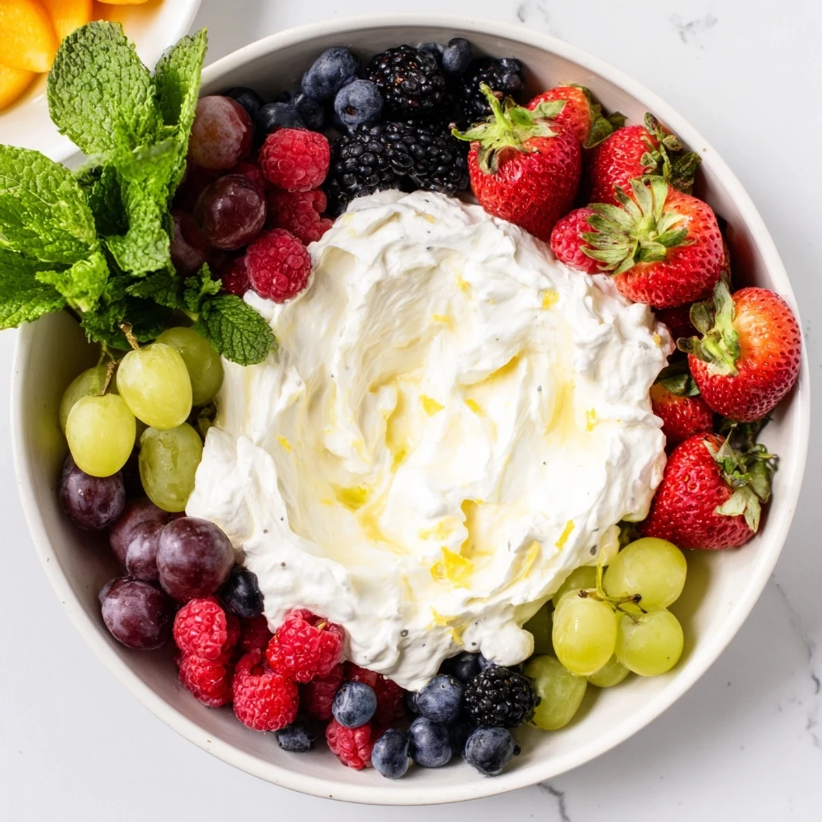Close-up of a delightful Mistletoe Kiss Berry Dip Board with ripe berries surrounding a creamy central dip.