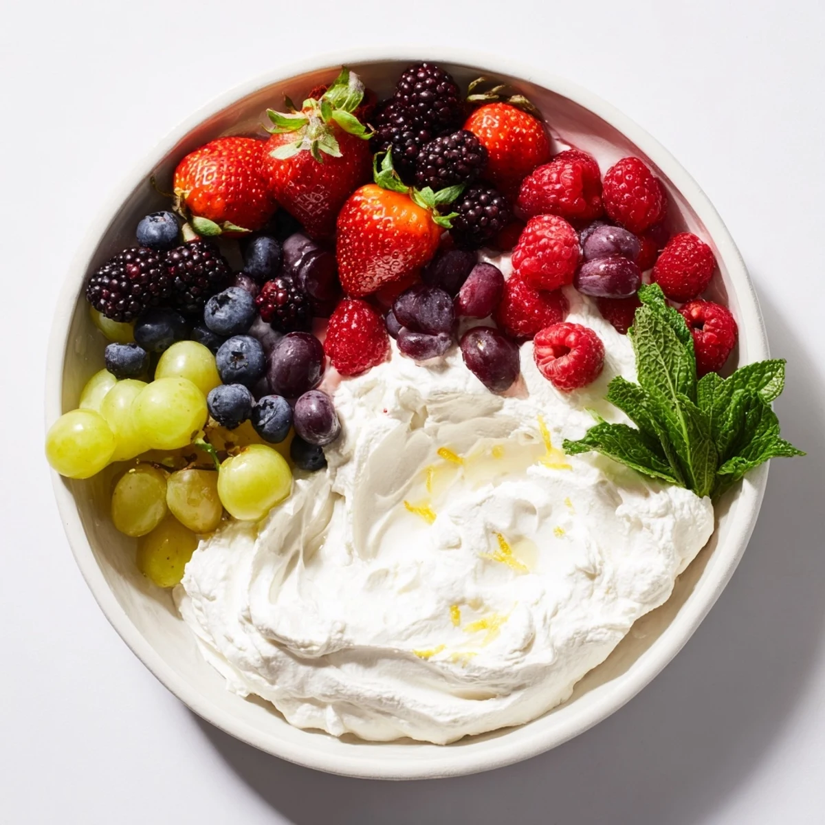 This Mistletoe Kiss Berry Dip Board features a festive arrangement of fresh fruit alongside a smooth, delicious dip.