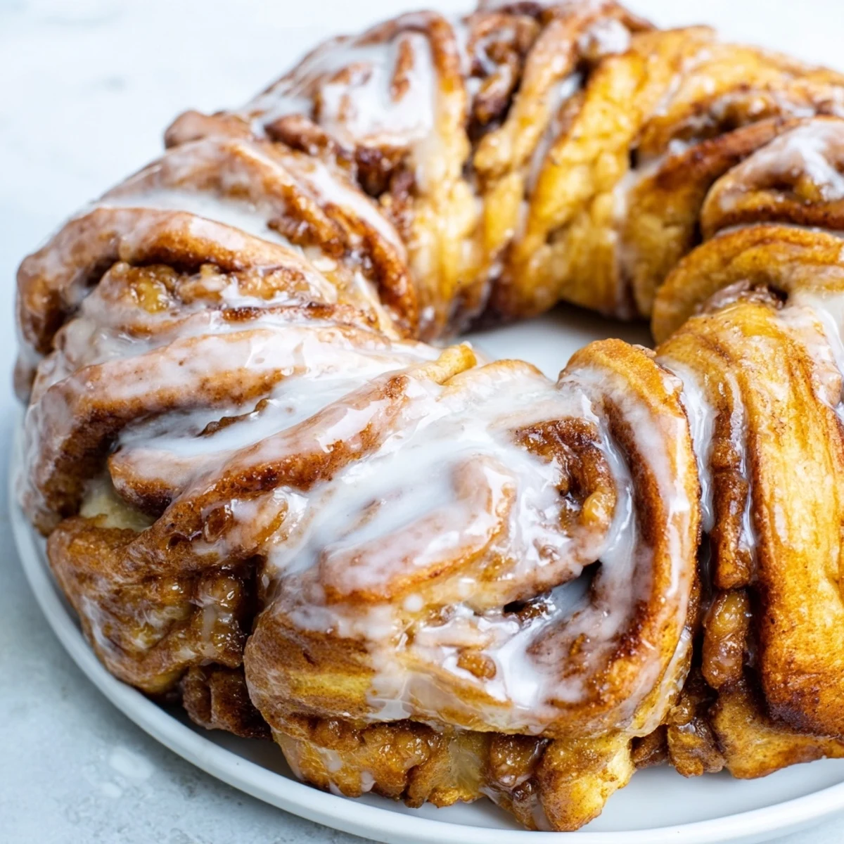 Warm, gooey Cinnamon Roll Pull-Apart Wreath with a sweet vanilla glaze drizzled over the top.