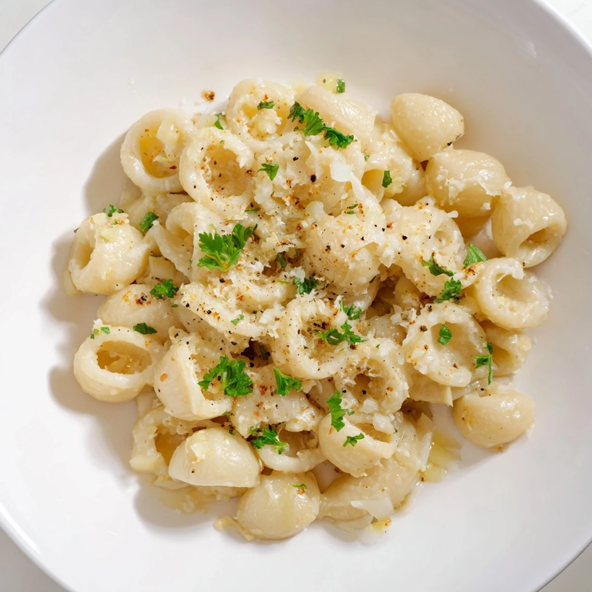 Close-up of a bubbling pot of One-Pot Garlic Butter Ditalini, with visible pasta and savory broth.
