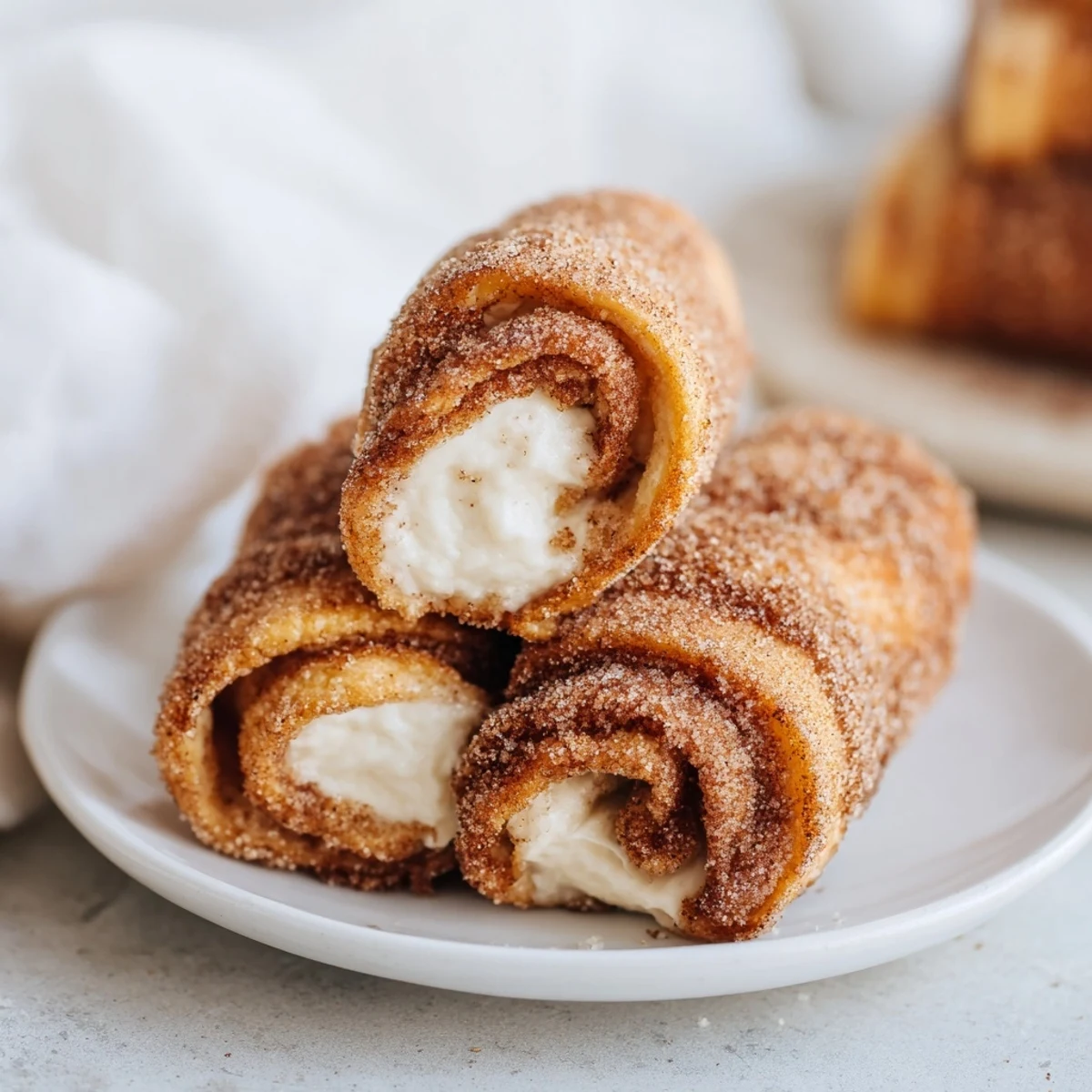 Warm, creamy interior peeking from perfectly cooked Easy French Toast Roll-Ups, ready to eat now.