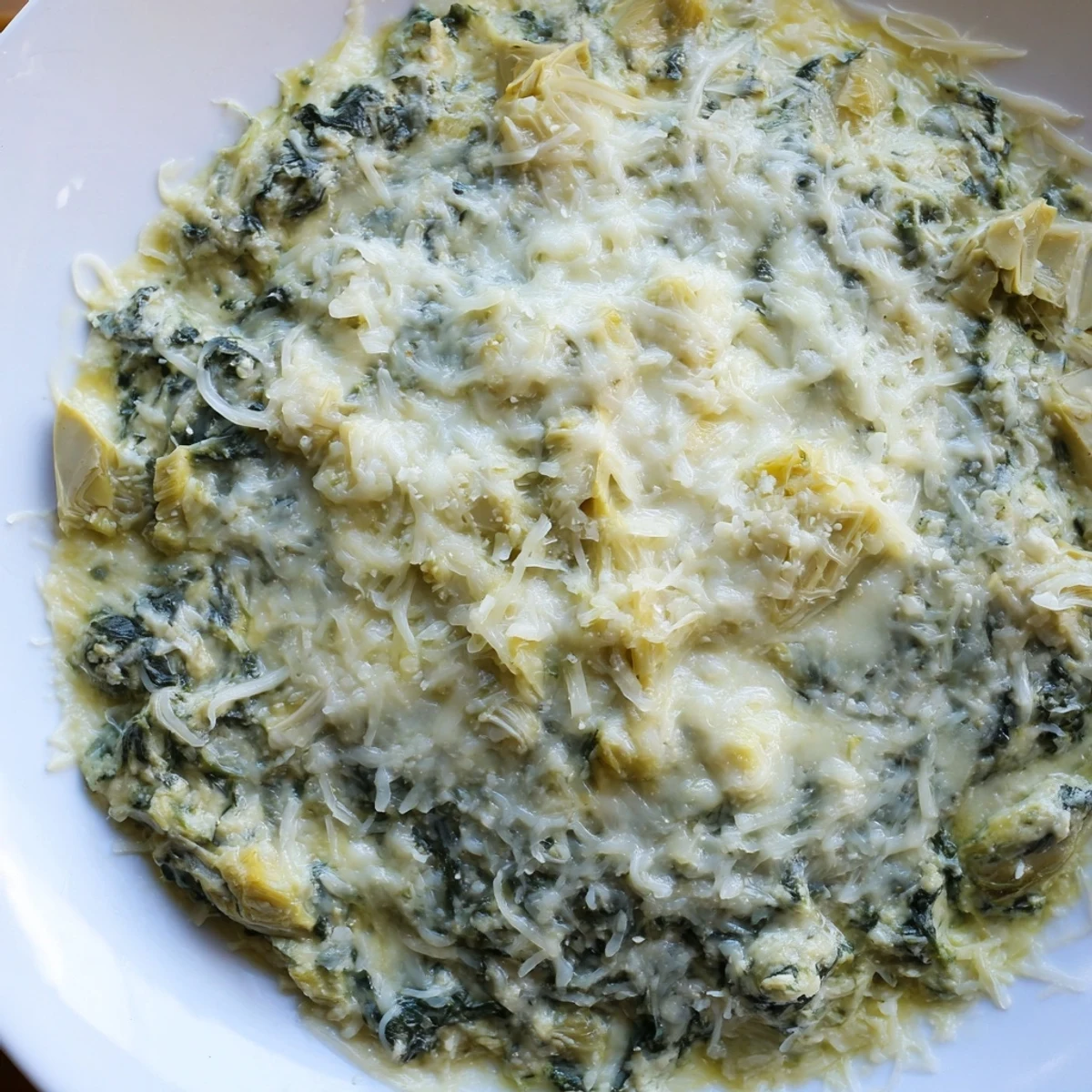 Golden-brown spinach artichoke dip, a crowd-pleasing appetizer with melted cheese and fresh herbs.