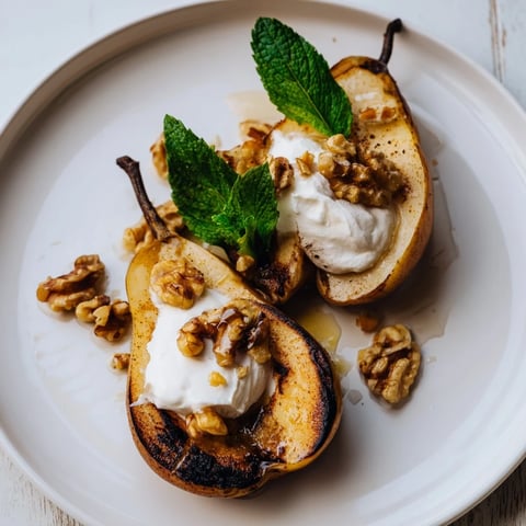 Warm roasted pears with cinnamon, walnuts, and Greek yogurt, a delightful dessert.