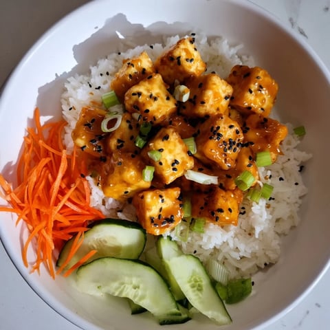 Golden, crispy chili-mayo baked tofu cubes nestled atop fluffy rice, ready to enjoy.