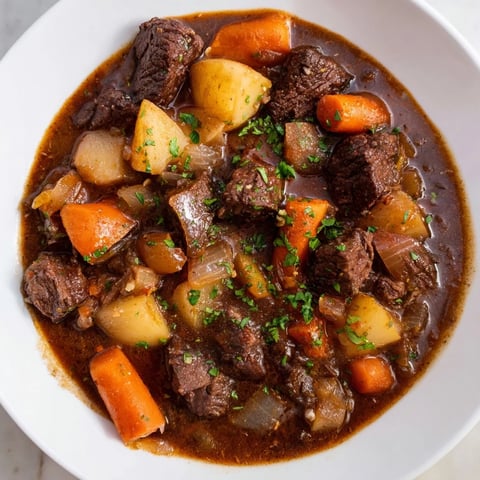 Tender Instant Pot Beef Stew with root vegetables, in a rich, flavorful broth, ready to eat.