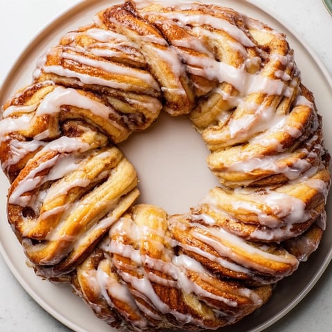 Golden-brown, fluffy Cinnamon Roll Pull-Apart Wreath, perfect for sharing at a festive brunch.