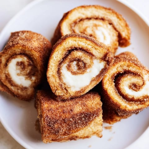 Golden, cinnamon-dusted Easy French Toast Roll-Ups, perfect for a quick and fun breakfast snack.