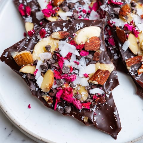 Creamy chocolate banana bark sprinkled with crunchy toppings, a perfect frozen dessert.