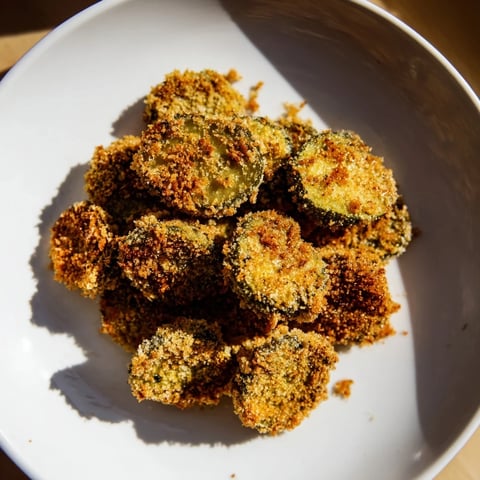 Golden, crispy Fried Pickles, ready to dip in ranch, offer a satisfying crunch.