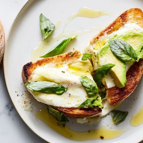 Creamy smashed avocado and melted mozzarella on crisp sourdough make this Avocado Mozzarella Tartine a perfect light lunch.