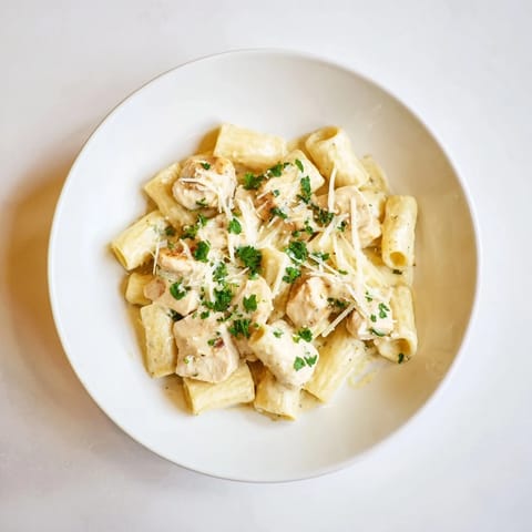 Golden chicken pieces and al dente rigatoni nestled in a delicious Creamy Garlic Parmesan sauce.
