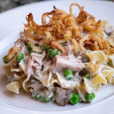 A close-up of creamy Tuna Noodle Casserole featuring tender noodles and flavorful cheese.