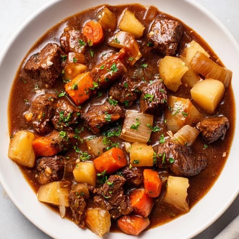 Steaming Instant Pot Beef Stew, a comforting classic loaded with hearty root vegetables.