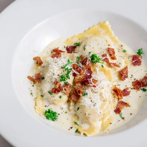 A close-up shot of rich Olive Garden Ravioli Carbonara showcasing the creamy sauce and perfectly cooked pasta.