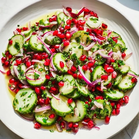 Festive Healthy Cucumber Christmas Salad, featuring colorful vegetables and a tangy dressing, perfect for holidays.