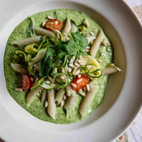 Creamy Vegan Green Goddess Pasta dish with a bright green spinach sauce, a vegan delight.