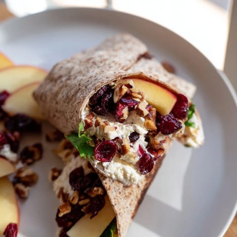 Mouthwatering, rolled Cranberry Goat Cheese & Walnut Holiday Wrap, ready for a flavorful lunch.