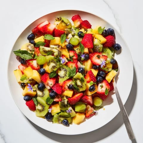 This Festive Bow Fruit Medley, with glistening berries and citrus, looks light, refreshing, and ready to serve.