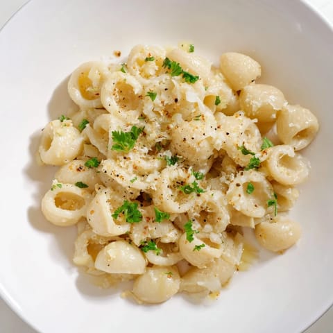 Close-up of a bubbling pot of One-Pot Garlic Butter Ditalini, with visible pasta and savory broth.