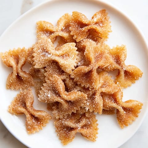 Close-up of air-fried Air Fryer Pasta Christmas Crack, a sweet treat dusted with cinnamon sugar, ready to eat.
