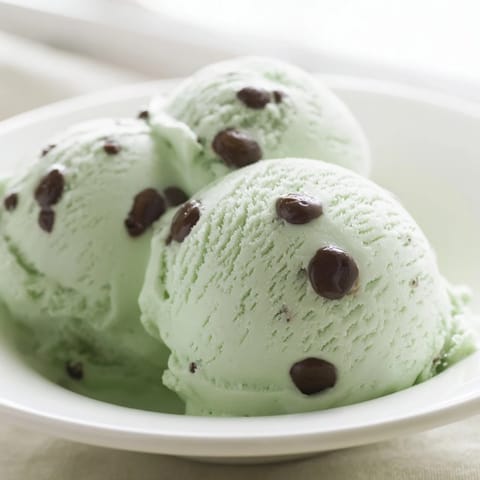 Rich, homemade Mint Chocolate Chip Ice Cream, perfect for a summer treat, swirls with green and cocoa.