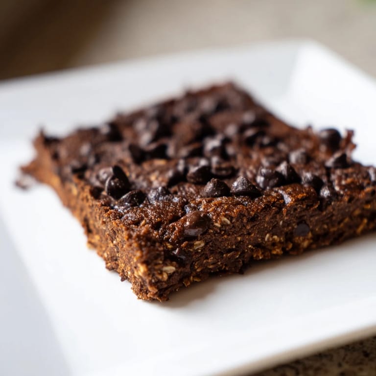 Close-up of baked sweet potato brownies, highlighting a soft, chocolatey interior.