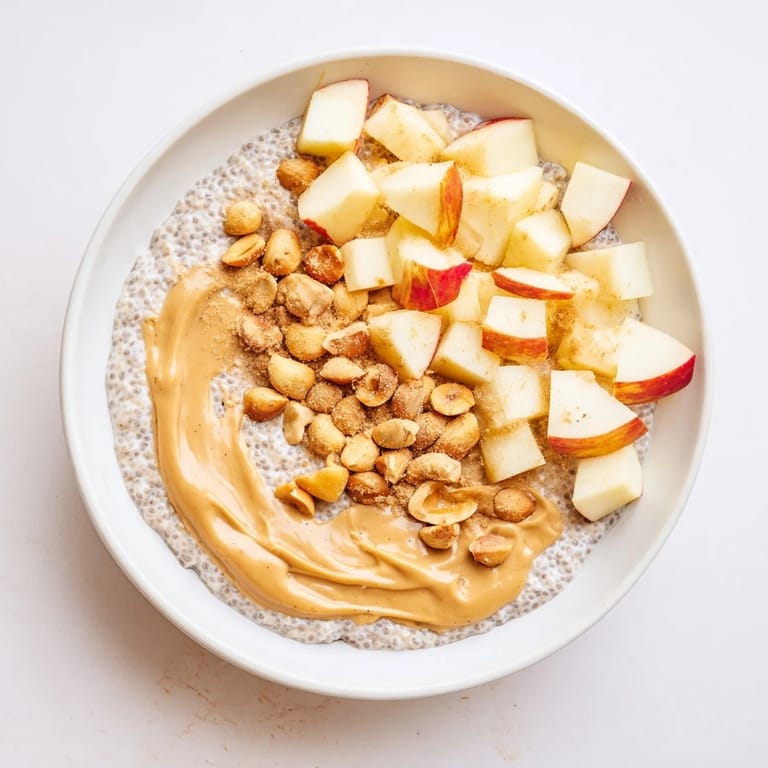 A spoonful of Apple-Chia Pudding with Peanut Butter, offering a delightful mix of flavors and textures.