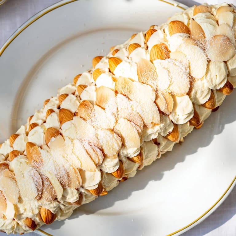 Impressive snowy pinecone centerpiece: a vegetarian appetizer, ready to serve with crackers and grapes.
