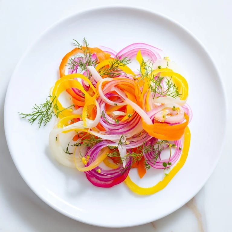 Crisp and refreshing, this Spinning Top salad showcases thinly shaved vegetables in a stunning arrangement with dressing.