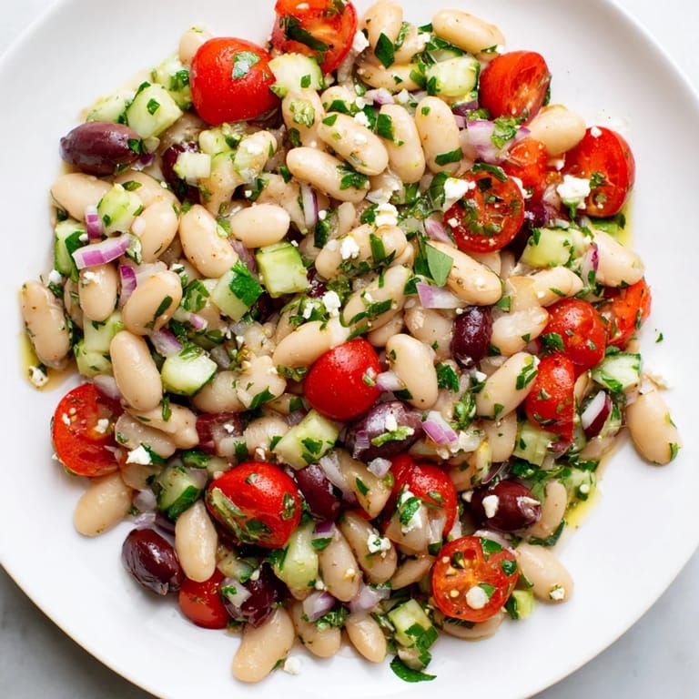 Homemade white bean salad showcasing creamy beans, ripe vegetables, with a zesty flavor profile.