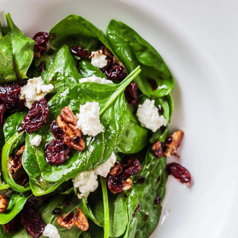 Easy Spinach Goat Cheese Salad recipe with baby spinach, tangy balsamic dressing, cranberries, and pecans, ideal for a quick vegetarian meal.