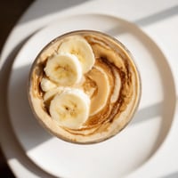 Creamy Peanut Butter Banana Smoothie, swirled in a tall glass, ready for a refreshing breakfast.
