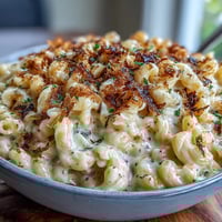 Creamy truffle mac and cheese baked with four cheeses, topped with golden panko and aromatic shaved black truffle for a gourmet comfort dish.