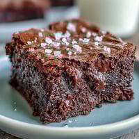 Fudgy sourdough discard brownies with sea salt, featuring rich dark chocolate and a hint of tangy sourdough, topped with flaky sea salt crystals.