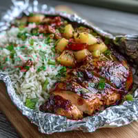 Juicy pineapple chicken and rice foil packets grilled to perfection with colorful vegetables.