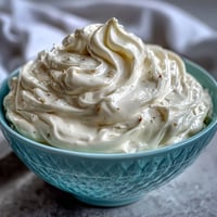 Creamy homemade mayonnaise in a glass jar, freshly blended with an immersion blender in just 5 minutes.