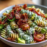 Vibrant BLT pasta salad with crispy bacon, cherry tomatoes, and fresh romaine in creamy avocado ranch dressing.